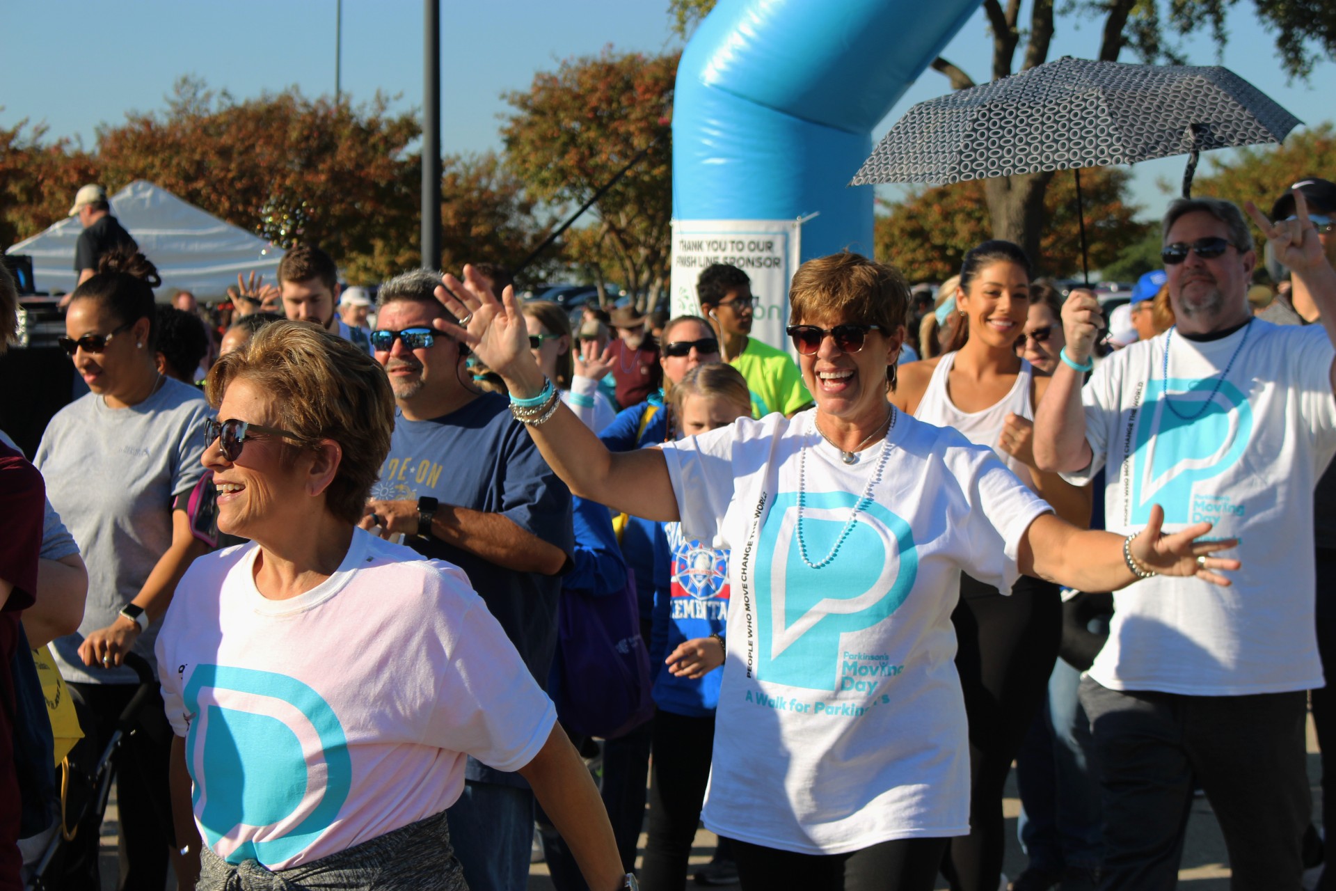 A group of people taking part in a walk for Parkinson's event. They are happy.