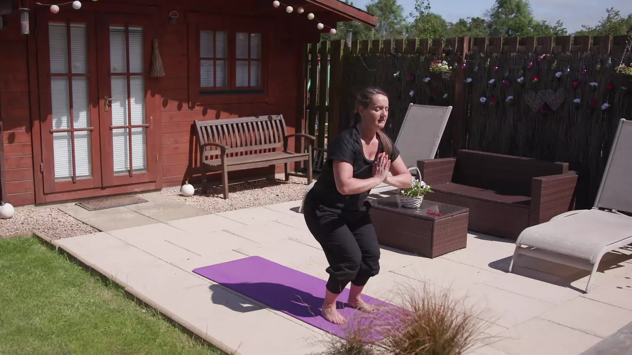 Woman doing yoga in garden