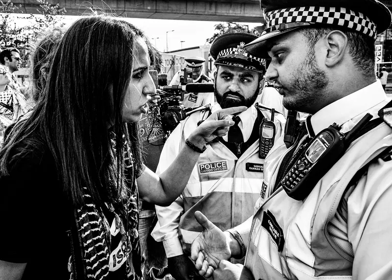 Image of girl clashing with police at protest