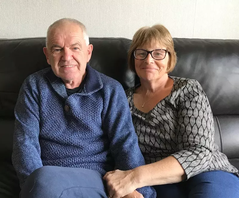 Andy and Susan sitting together on the sofa